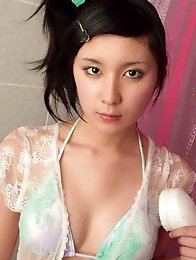 Gorgeous asian angel in sensual green lingerie taking a shower