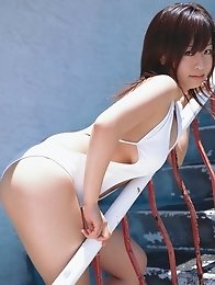 Cute asian babe showing off her tits at the beach in a bikini
