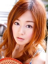 Red headed asian cutie posing in a floral printed dress